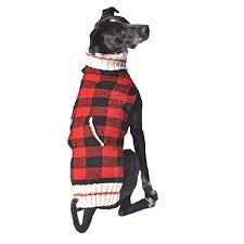 Black dog wearing a red and black buffalo plaid sweater with a white knit collar and trim