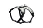 Black and grey dog harness with a small grey device attached to the top
