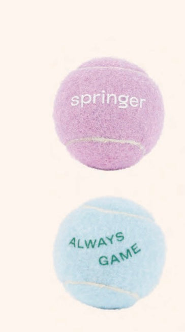 Springer tennis balls in light purple and light blue with printed text